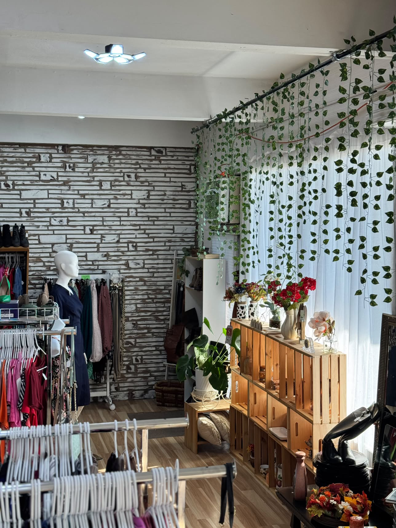 Clothing racks and a mannequin inside Jenny's Thrift Store