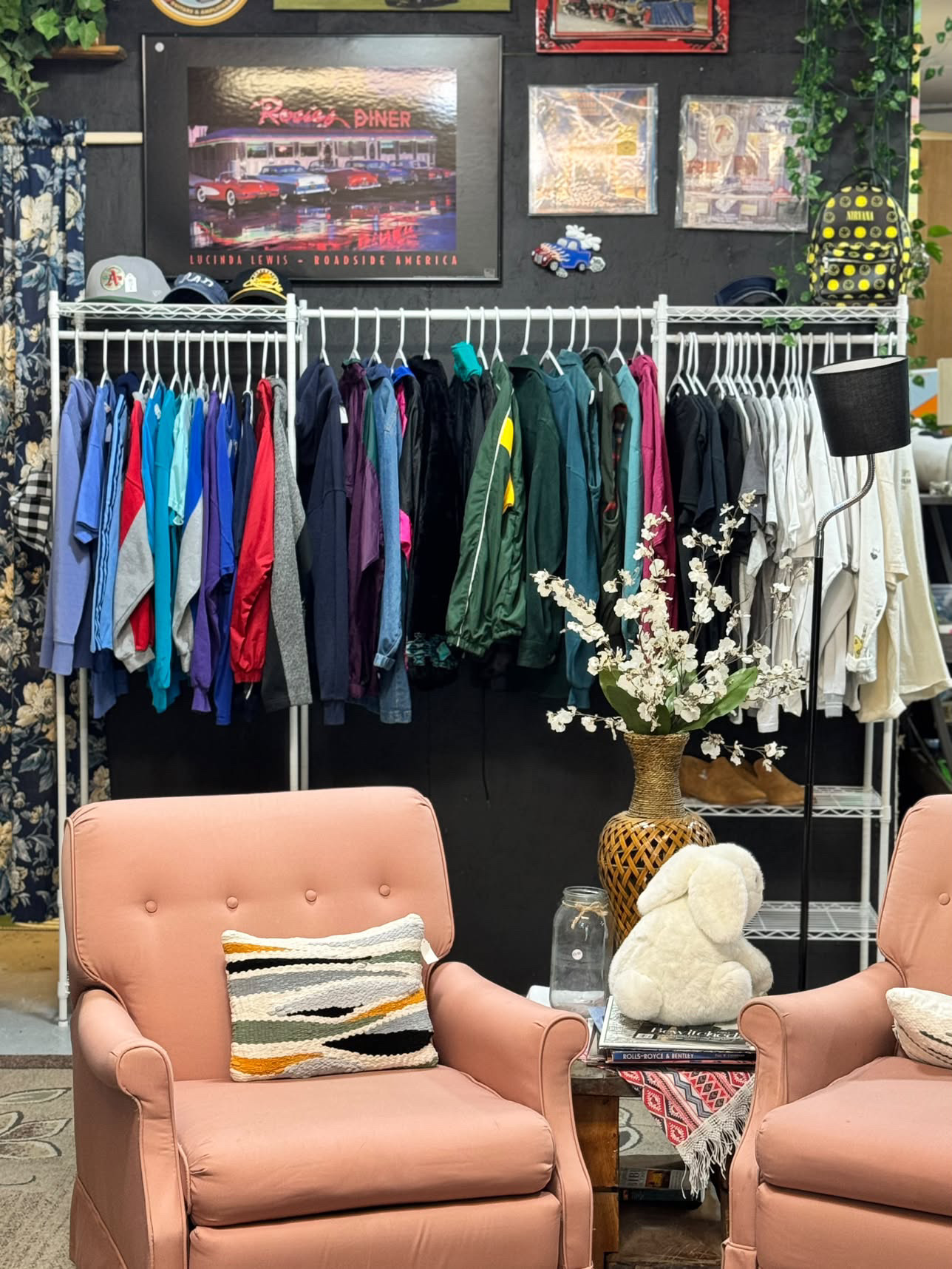 Pink armchairs and a rack of jackets in the store